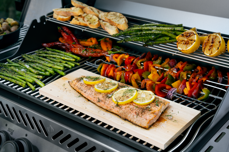 Rogue PRO 525 warming rack holding bread and vegetables above main grill area with seafood cooking below in Saint Johns Florida
