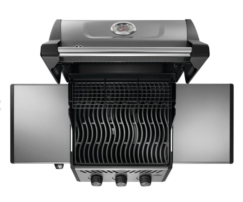 Top-down view of Napoleon Freestyle 365 grill with lid open showing cast iron porcelain-coated cooking grids, stainless steel burners, and sear marks on food